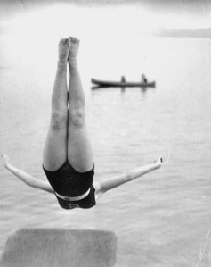 b&w photo of girl diving into a lake